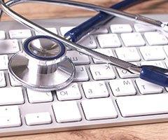 Stethoscope on keyboard, patient information